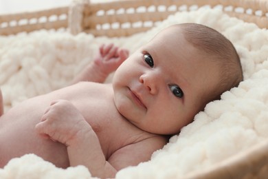 Photo of Adorable little baby lying in cradle, closeup