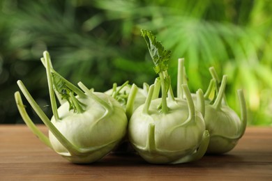 Photo of Whole ripe kohlrabi plants on wooden table