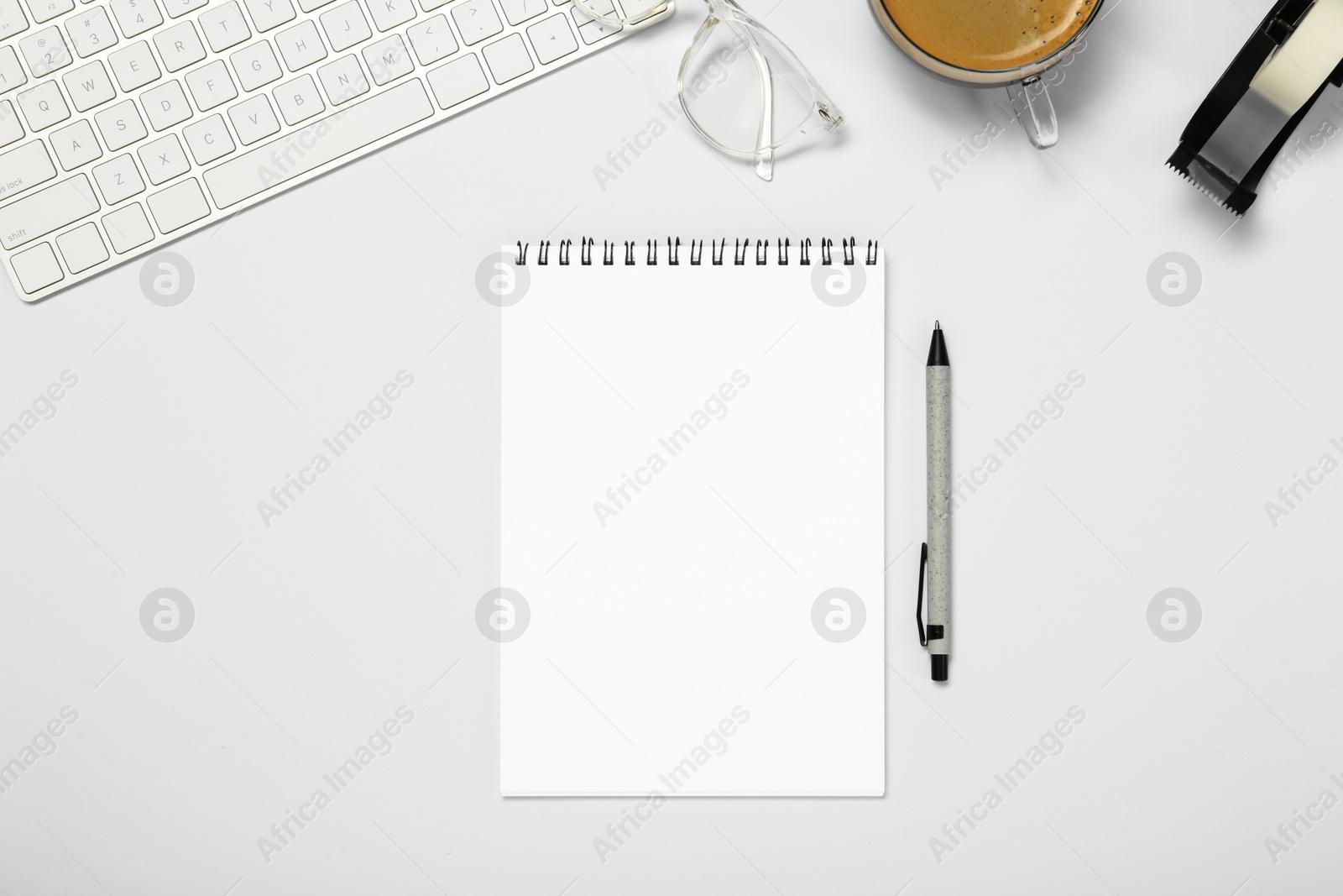 Photo of Flat lay composition with notebook and coffee on white table