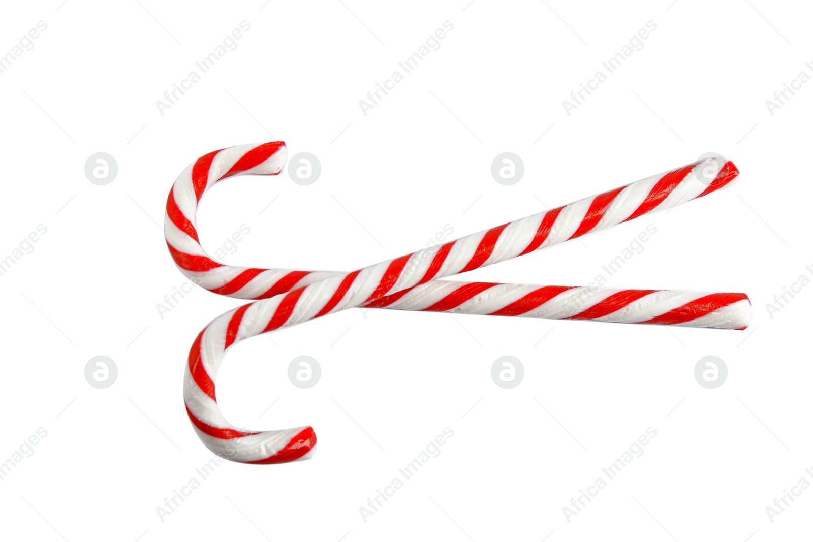 Photo of Candy canes on white background, top view. Traditional Christmas treat