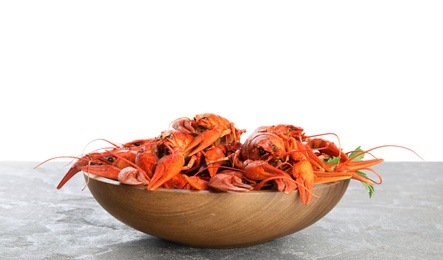 Photo of Delicious boiled crayfishes on grey table against white background