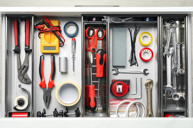 Set of instruments in open desk drawer, top view