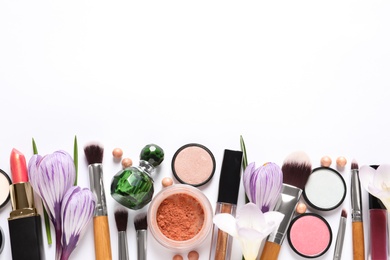 Photo of Different makeup products and flowers on white background, top view
