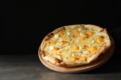 Photo of Hot cheese pizza Margherita on table against dark background. Space for text