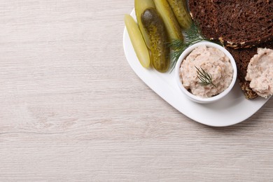 Delicious lard spread, bread and pickles on wooden table, top view. Space for text