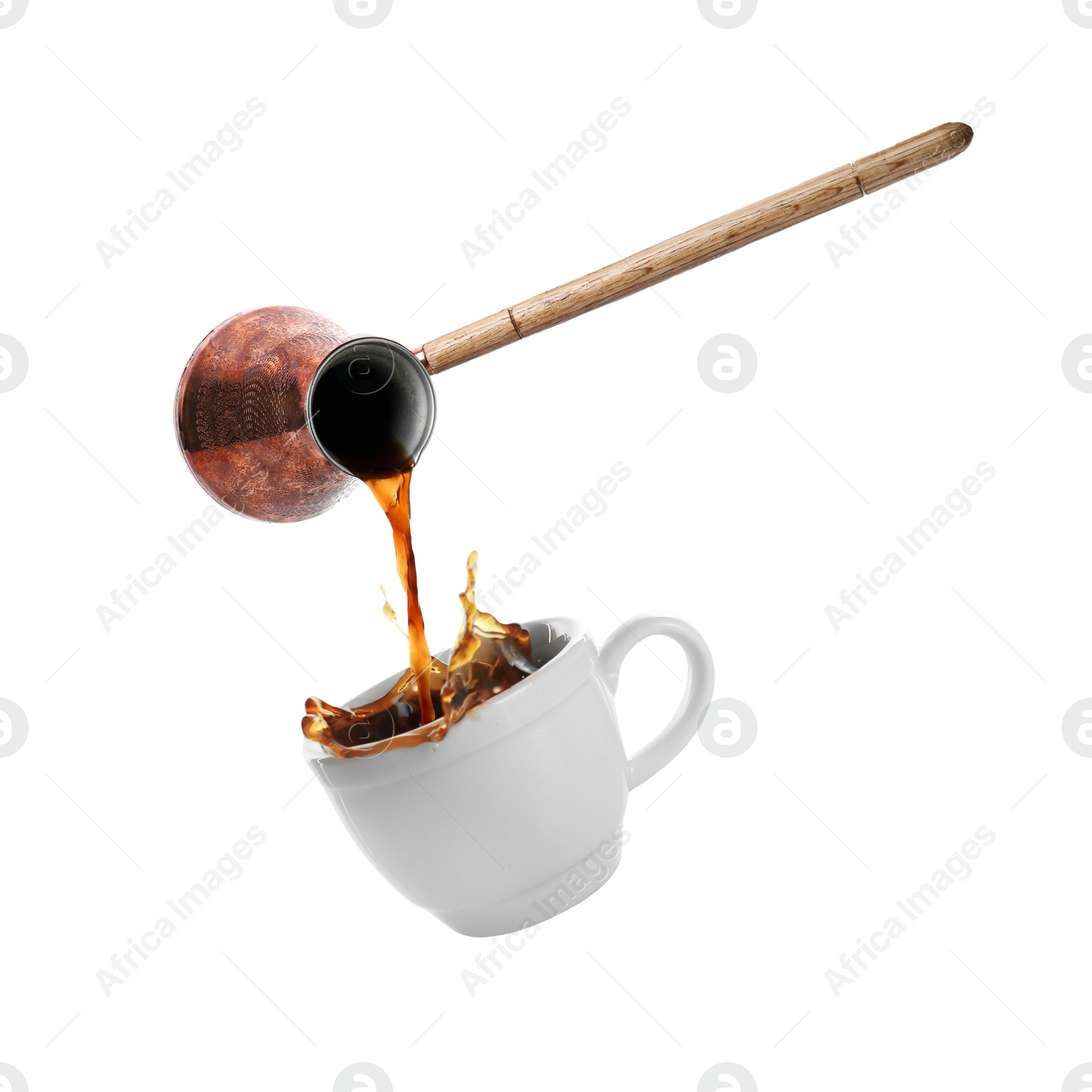 Image of Pouring freshly brewed aromatic coffee from turkish pot into cup. Objects in air on white background