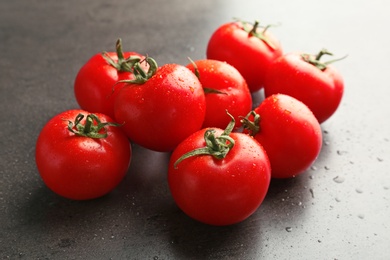 Photo of Fresh ripe tomatoes with water drops on grey background