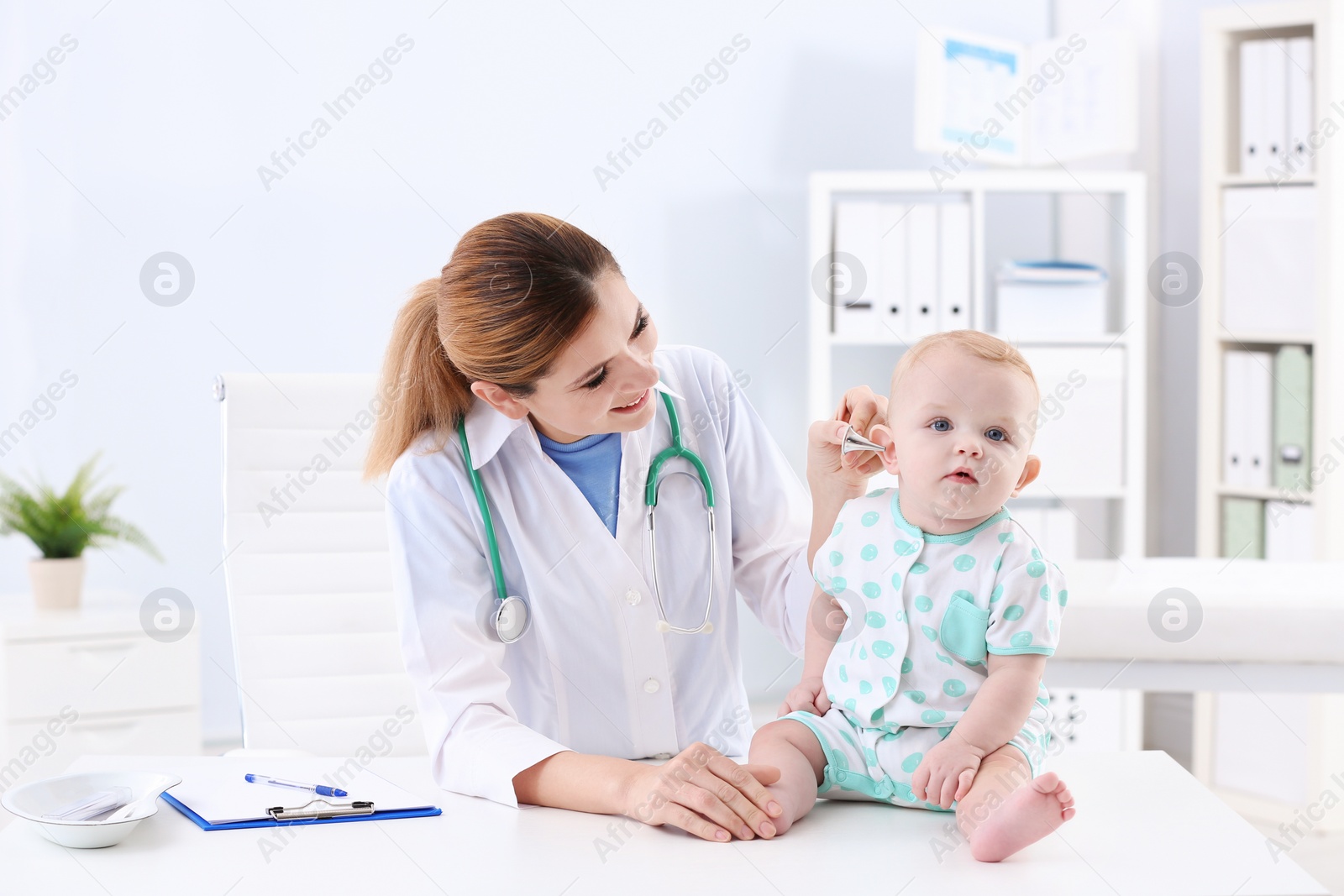 Photo of Children's doctor examining baby's ear in hospital