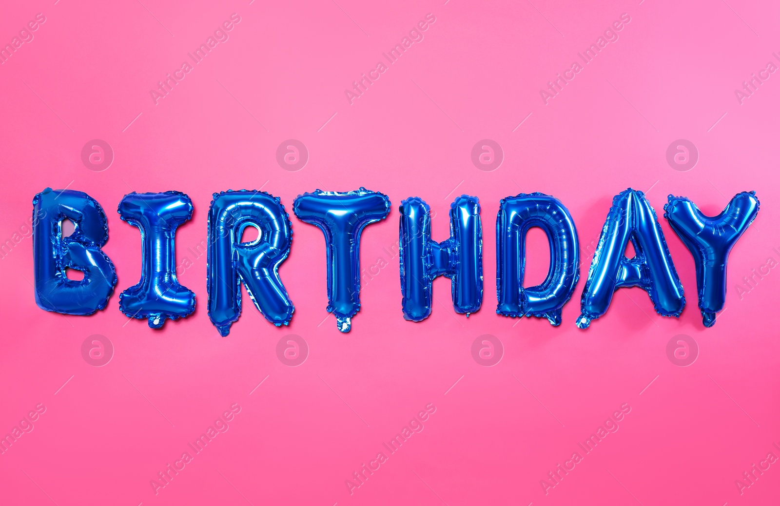 Photo of Word BIRTHDAY made of blue foil balloon letters on pink background