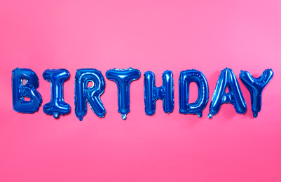 Word BIRTHDAY made of blue foil balloon letters on pink background