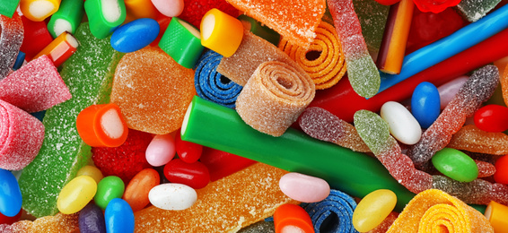 Image of Delicious colorful chewing candies as background, top view. Banner design 