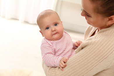 Photo of Young woman and her little baby at home