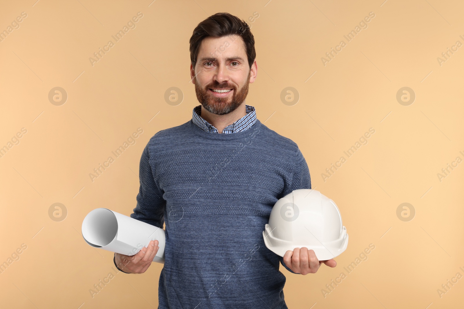 Photo of Architect with hard hat and draft on beige background