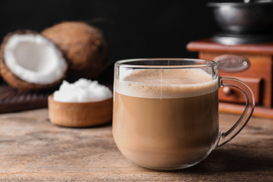 Delicious coffee with organic coconut oil on wooden table