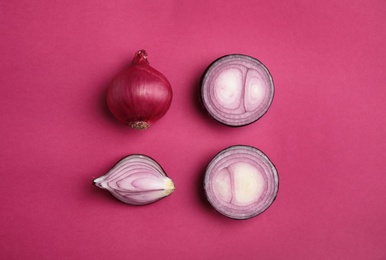 Beautiful composition with ripe red onions on color background