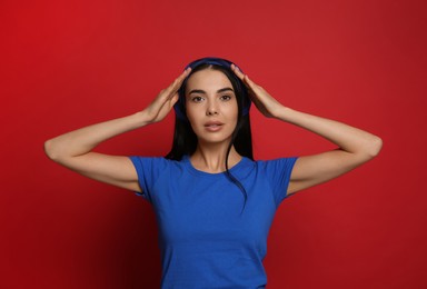 Photo of Young woman wearing stylish bandana on red background