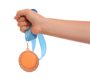 Woman holding gold medal on white background, closeup