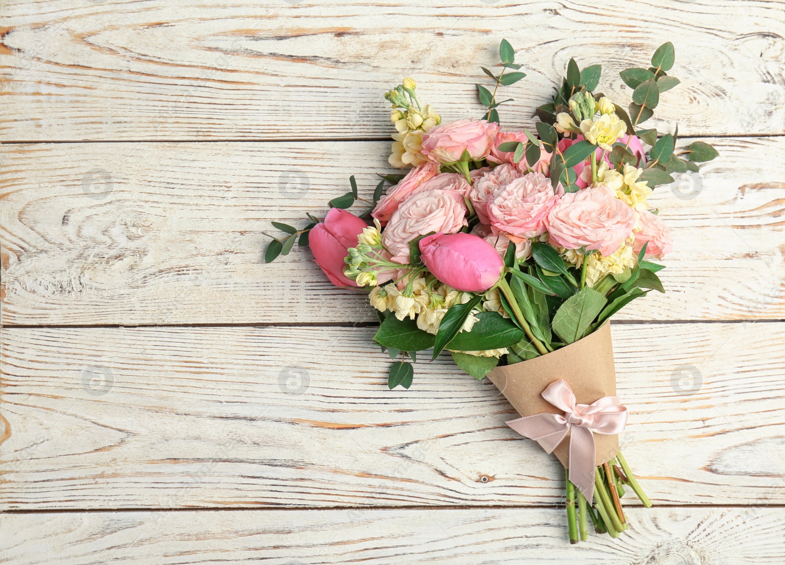 Photo of Bouquet of beautiful fragrant flowers on wooden background