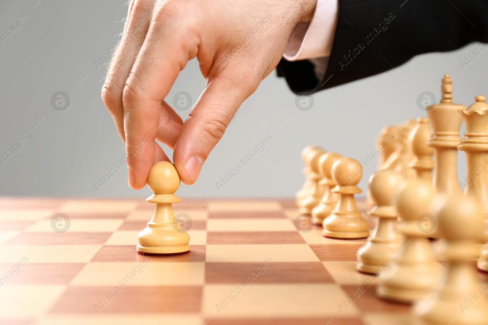 Photo of Man moving chess piece on board, closeup