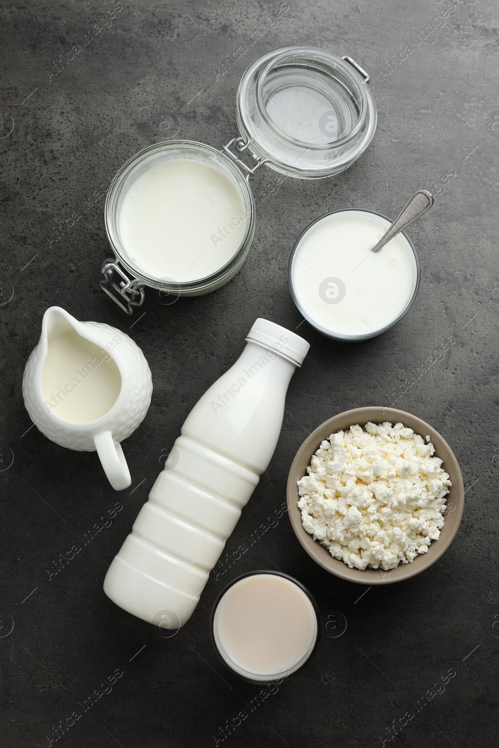 Photo of Many different lactose free dairy products on grey textured table, flat lay