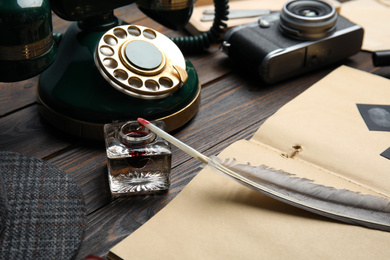 Photo of Composition with vintage detective items on wooden table, closeup