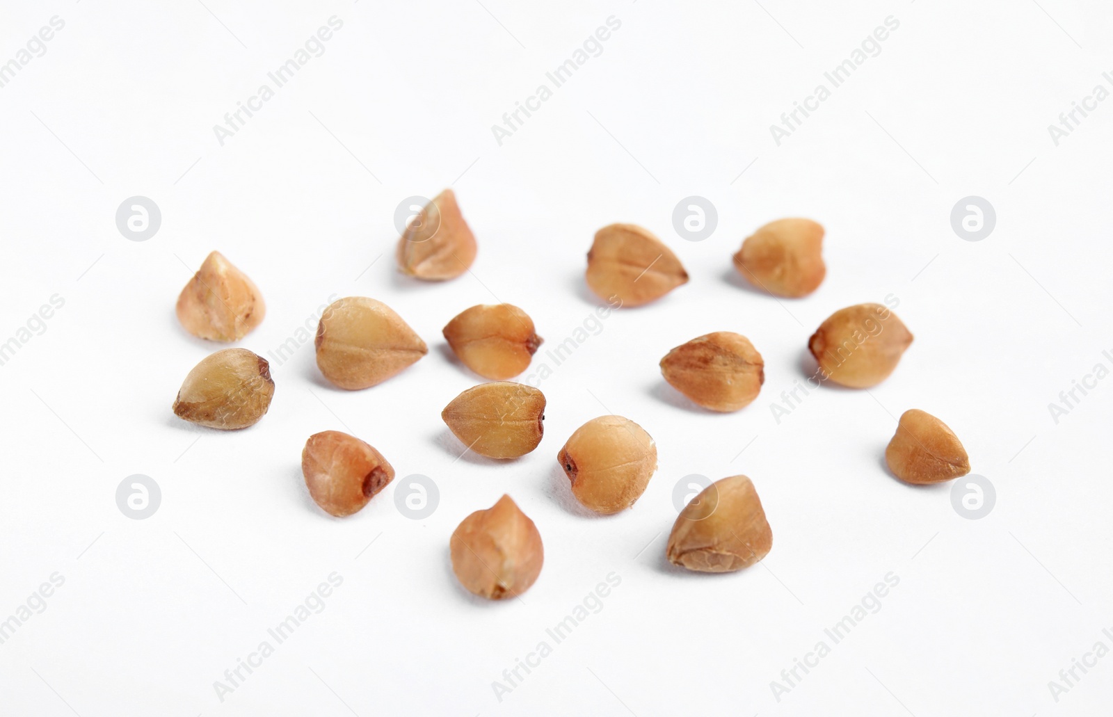 Photo of Uncooked buckwheat on white background. Healthy diet