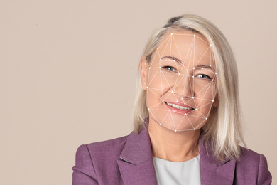 Image of Facial recognition system. Mature woman with biometric identification scanning grid on beige background, space for text