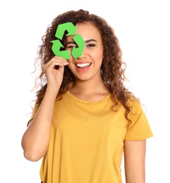 Young African-American woman with recycling symbol on white background