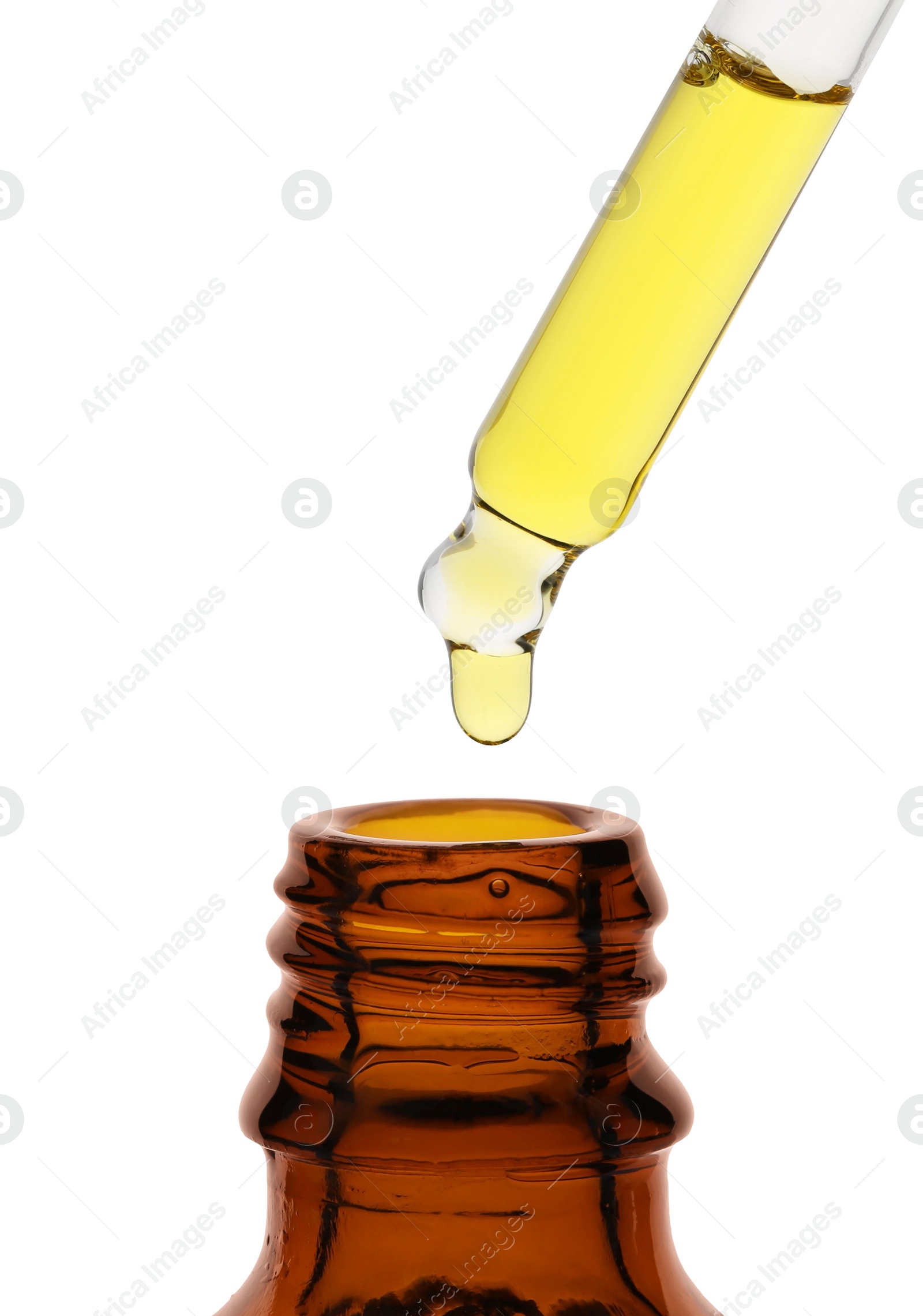 Photo of Dripping tincture from pipette into bottle isolated on white