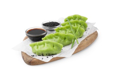 Photo of Delicious green dumplings (gyozas), soy sauce and sesame seeds isolated on white