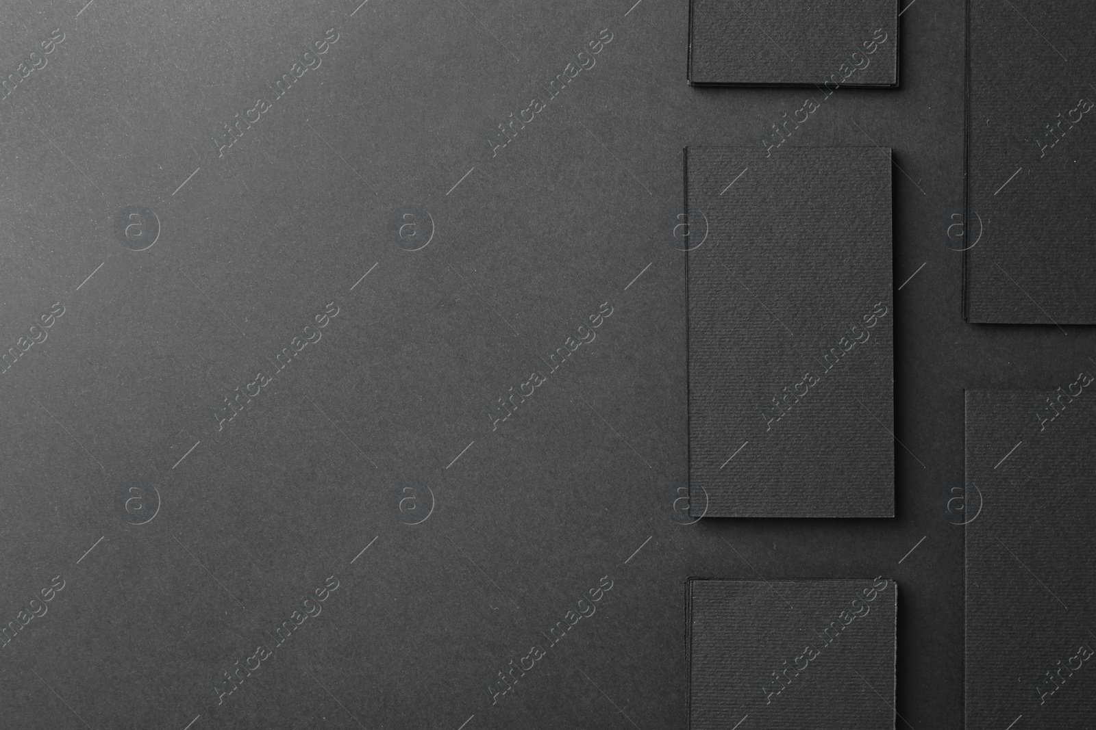 Photo of Blank business cards on black background, flat lay. Mockup for design