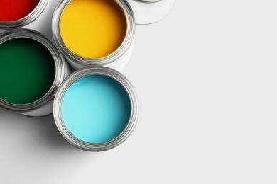 Open paint cans on white background, top view. Space for text