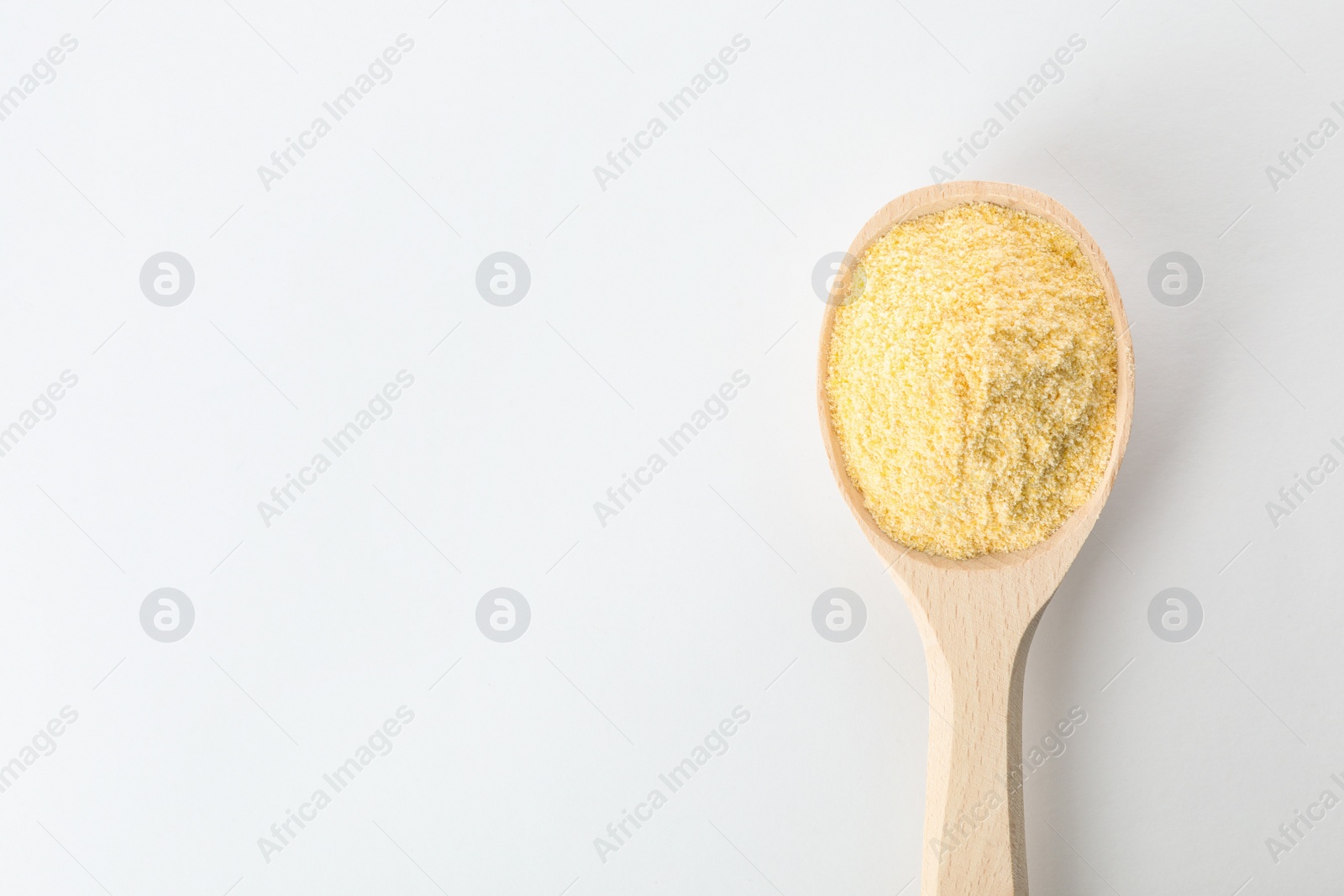 Photo of Spoon of corn flour isolated on white, top view with space for text