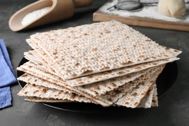 Photo of Stack of traditional matzos on grey table