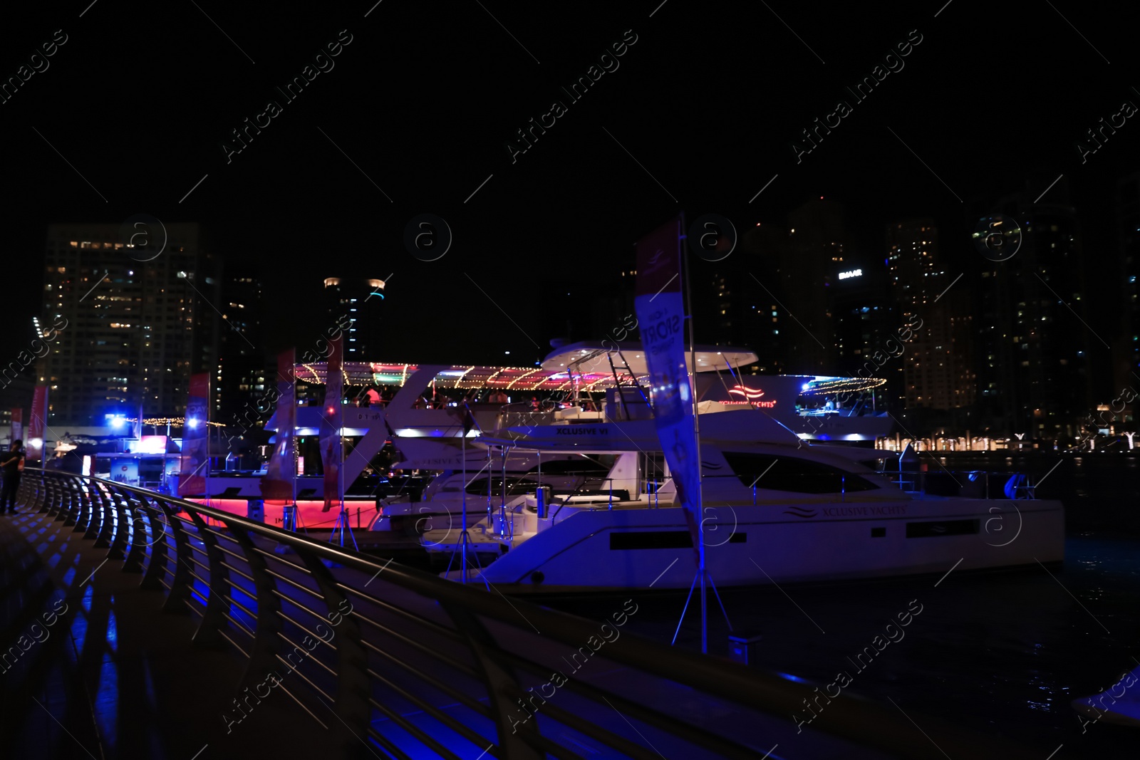 Photo of DUBAI, UNITED ARAB EMIRATES - NOVEMBER 03, 2018: Pier with luxury yachts at night