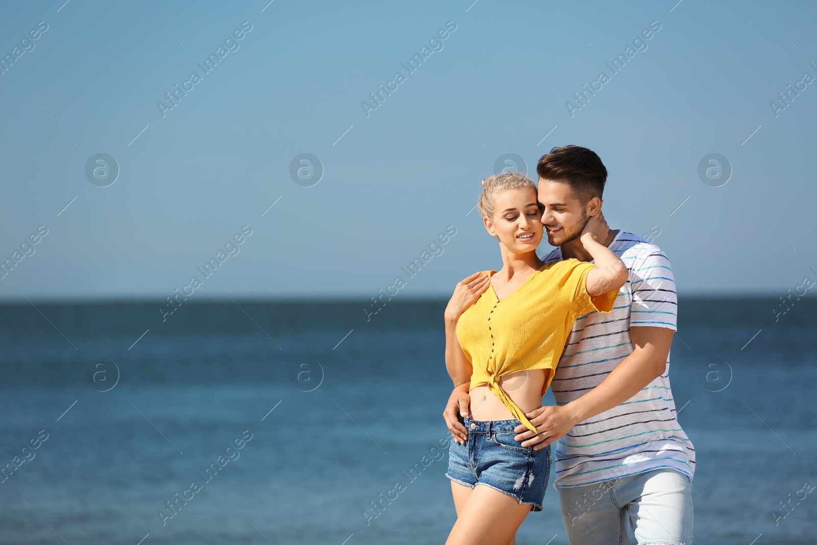 Photo of Happy young couple at beach on sunny day