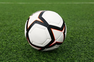 Photo of New soccer ball on green football field