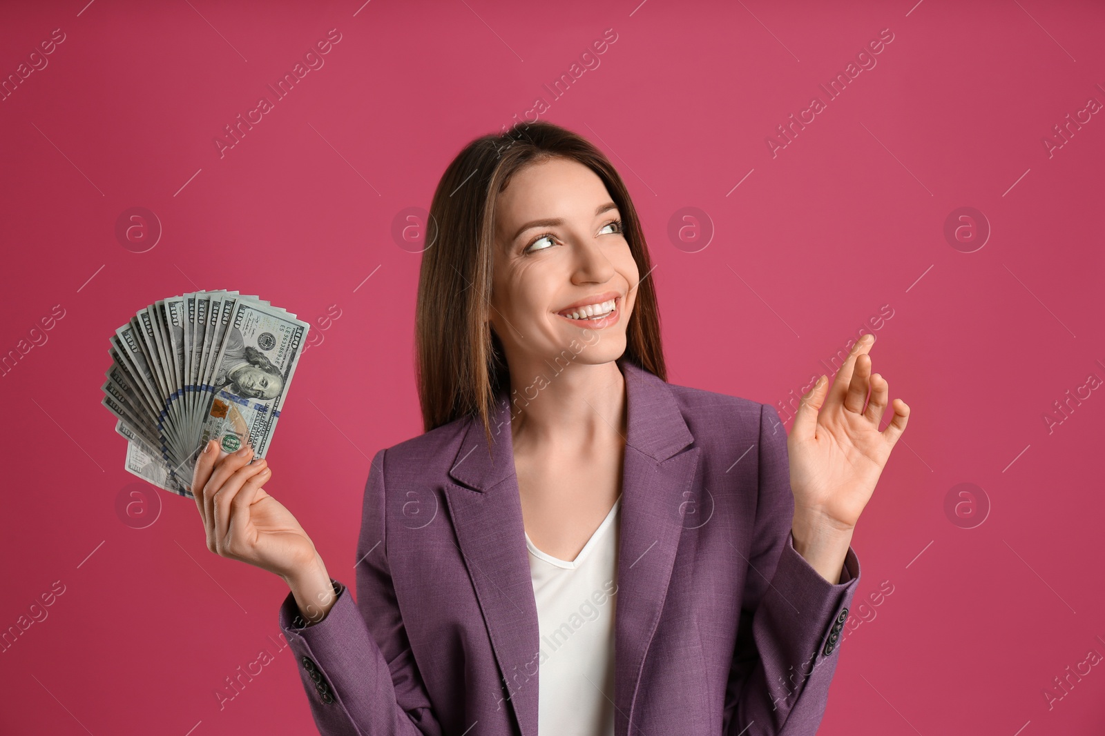 Photo of Happy young woman with cash money on pink background