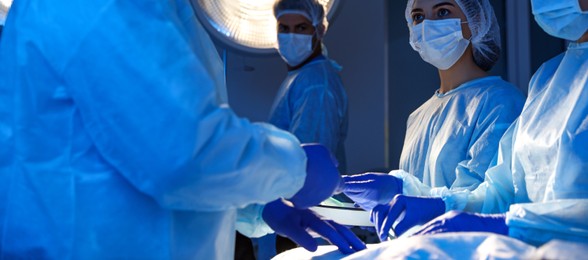 Image of Team of professional doctors performing operation in surgery room. Banner design