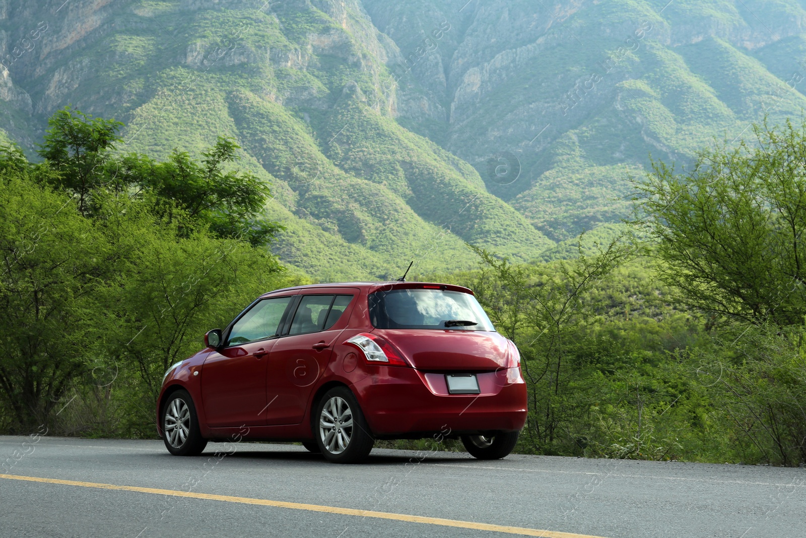 Photo of Beautiful view of car on asphalt highway in mountains. Road trip