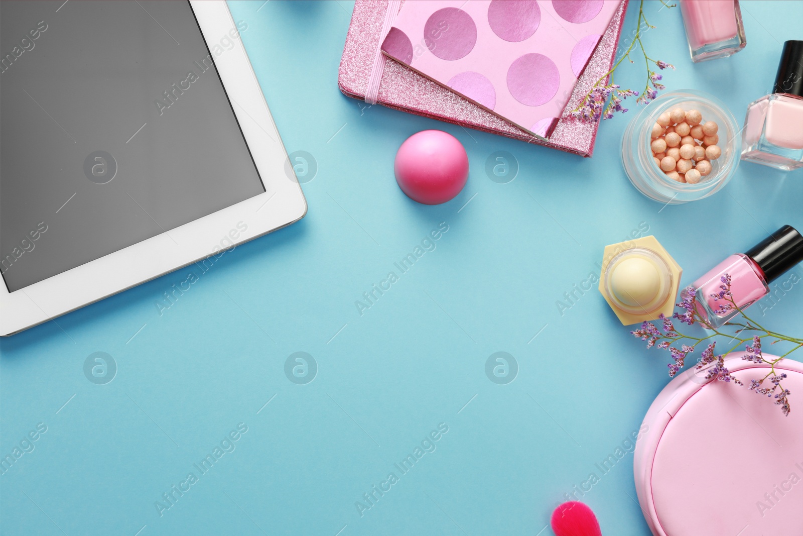 Photo of Flat lay composition with tablet on blue background. Beauty blogger's workplace