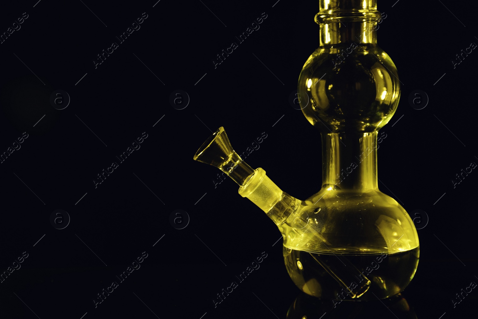 Photo of Glass bong on black background, space for text. Smoking device