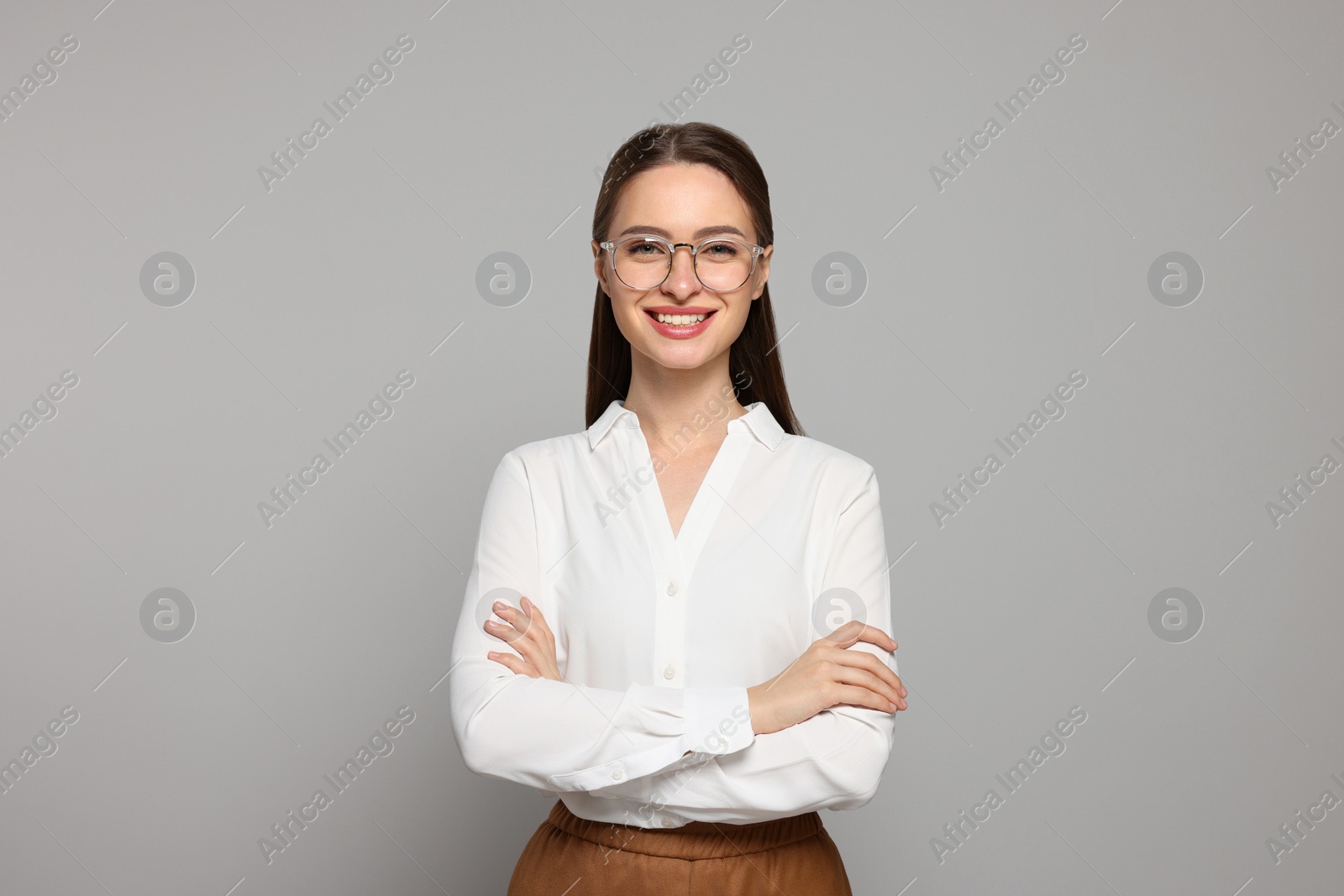 Photo of Portrait of beautiful young teacher on grey background