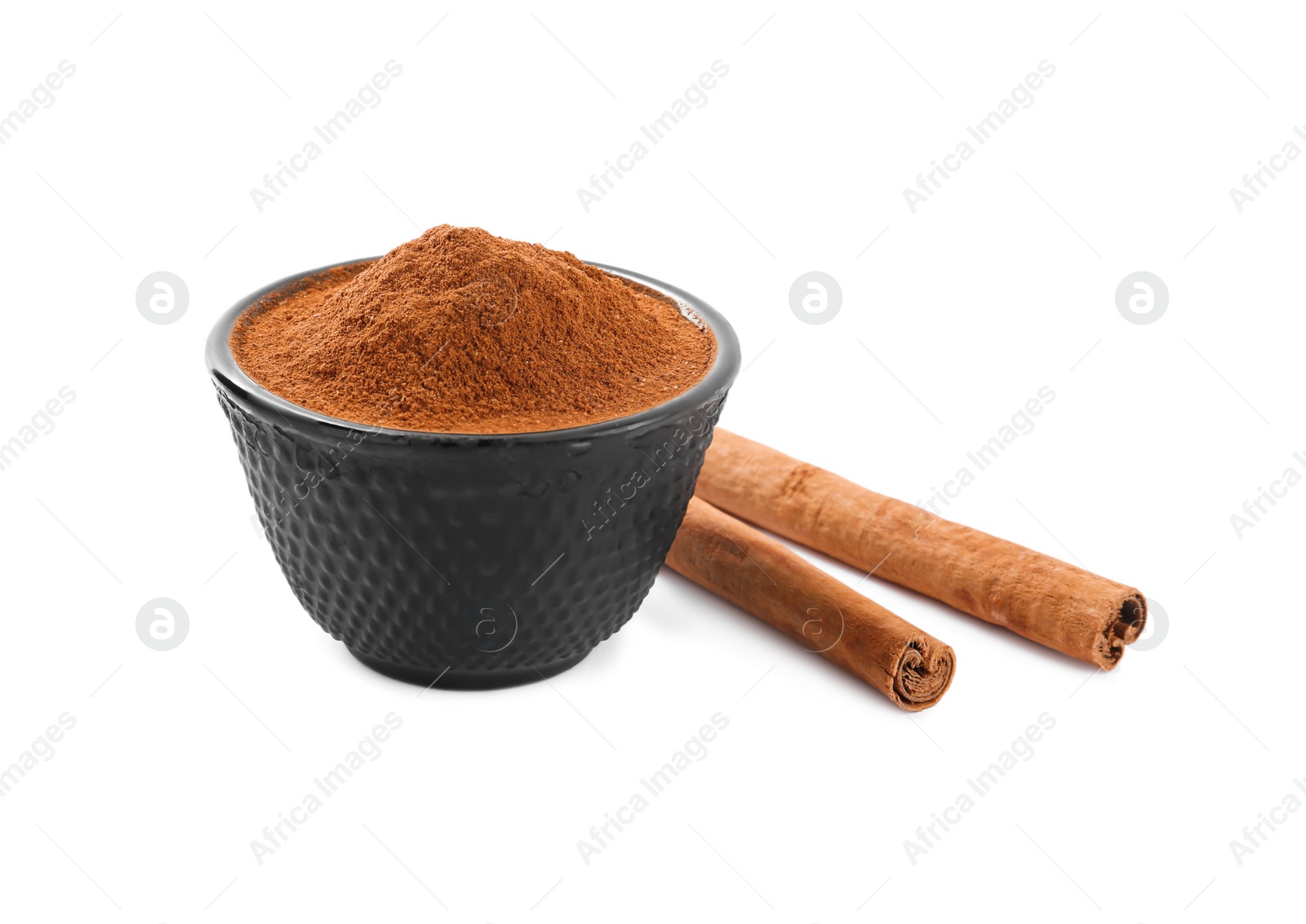 Photo of Aromatic cinnamon sticks and bowl with powder on white background