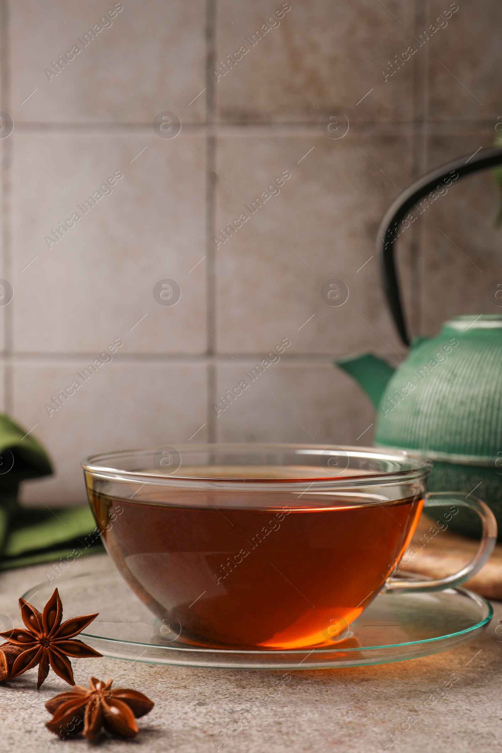 Photo of Aromatic tea with anise stars on light grey table