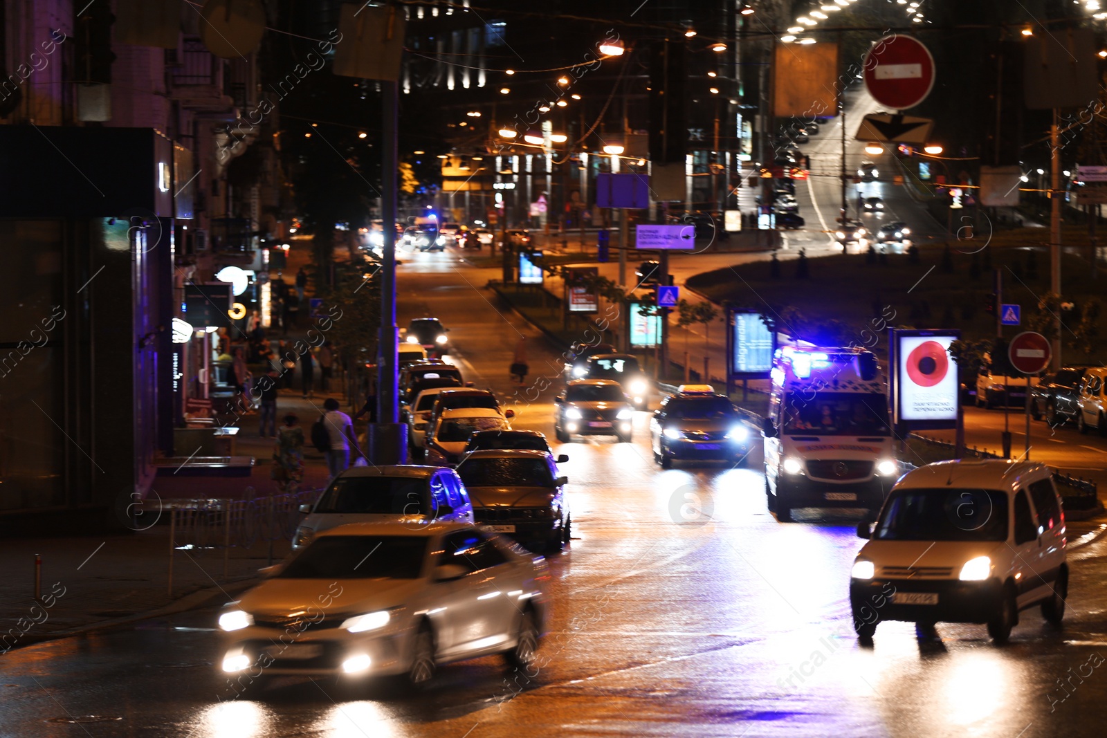 Photo of KYIV, UKRAINE - MAY 22, 2019: View of illuminated city street with road traffic