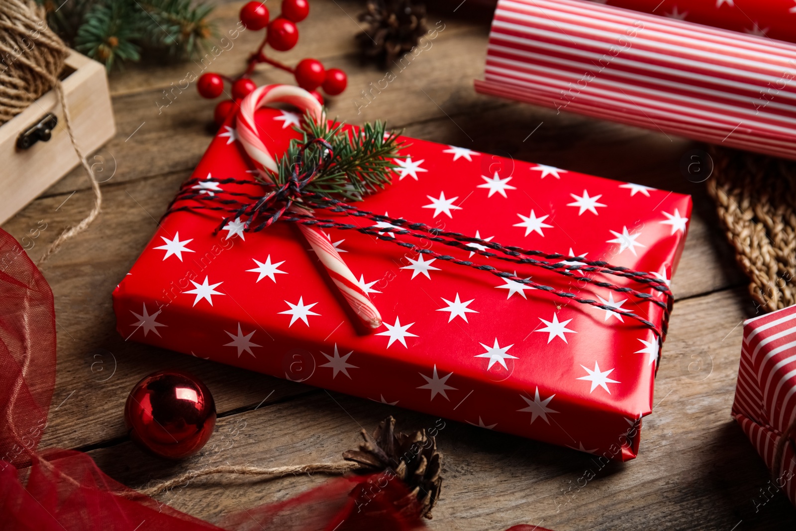 Photo of Composition with beautifully wrapped gift box on wooden table