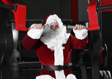 Young Santa Claus training in modern gym