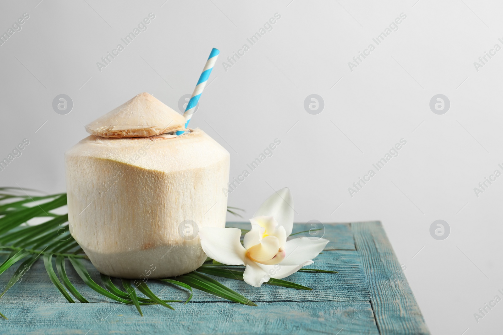 Photo of Fresh coconut drink in nut on table