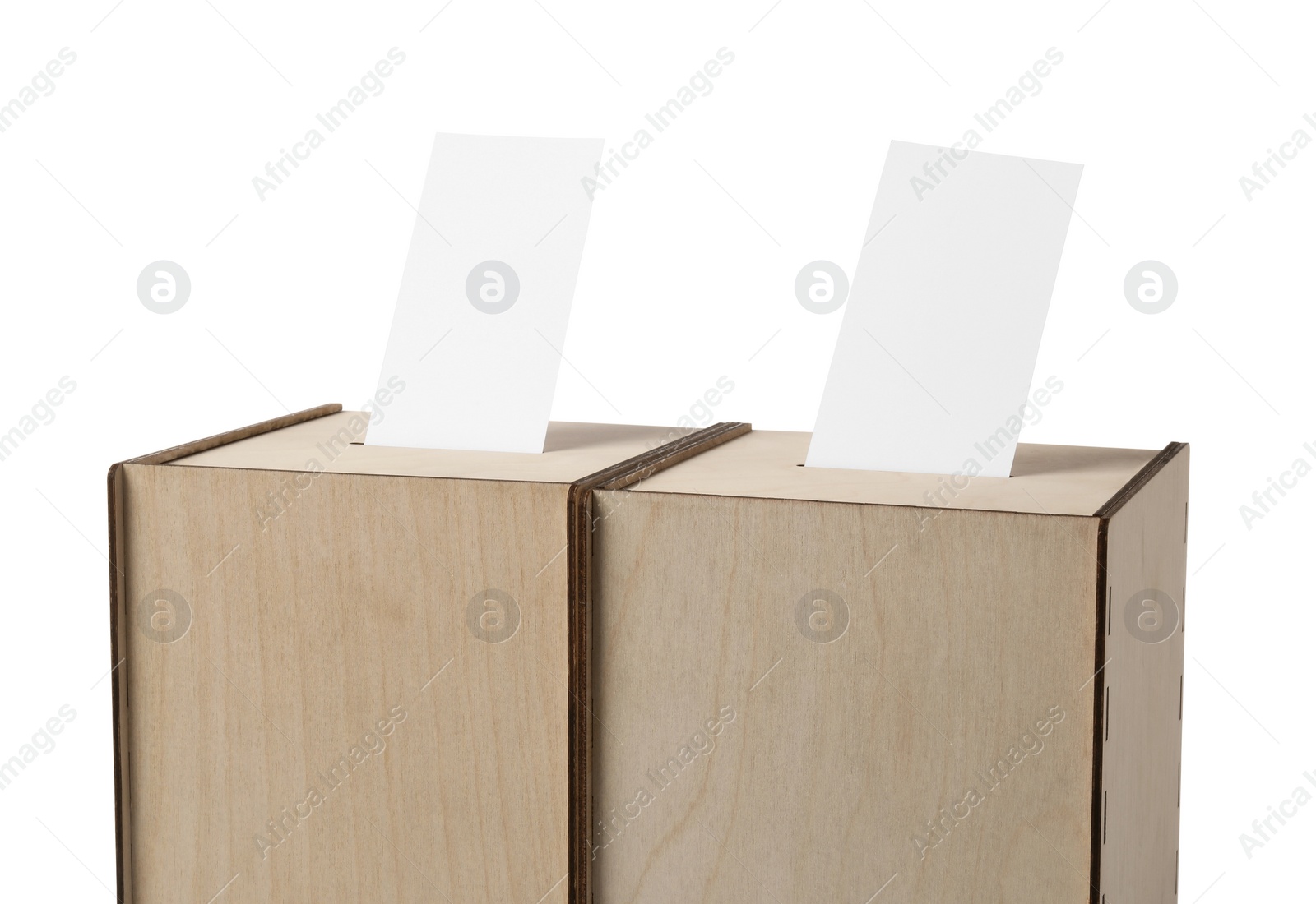 Photo of Wooden ballot boxes with votes isolated on white